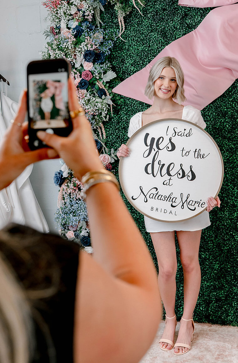Bride holding a “I Said Yes to the Dress” sign