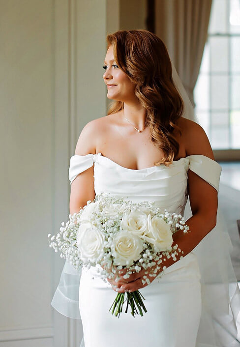 Bride holding a white rose bouquet